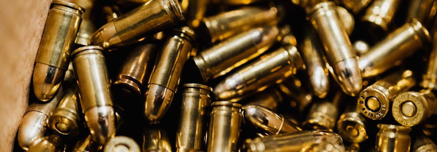 Detailed close-up of brass bullets in a box, showcasing ammunition storage.